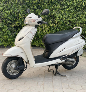 Used Bike White Honda Activa on paving stones - Winloo