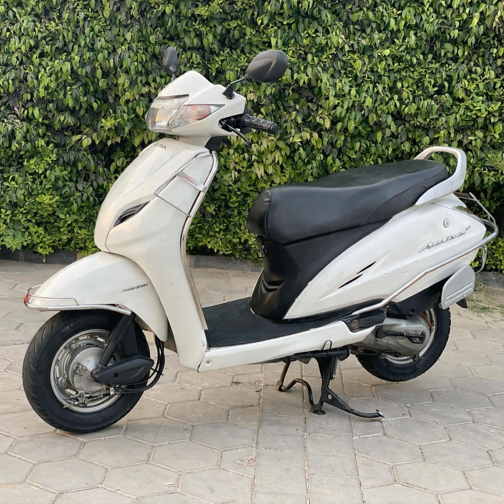 Used Bike White Honda Activa on paving stones - Winloo